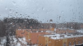 Close up of a window with rain drops falling down. Focus on rain drops. Rain drops on outside window glass with blurred edges. Window pane in autumn-winter time. - Powered by Shutterstock - Get 15% off with code: PIKWIZARD15