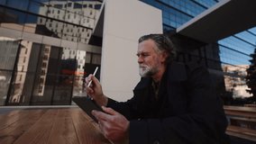 Focused businessman working on digital tablet with stylus, analyzing data or creating strategy report. Mature professional reviewing charts or graphs, planning business goals, and decisions - Powered by Shutterstock - Get 15% off with code: PIKWIZARD15