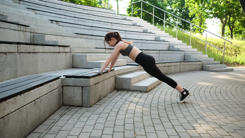 Girl Doing Push-Ups Outside As Part Of Training And Female Bodybuilding Routine