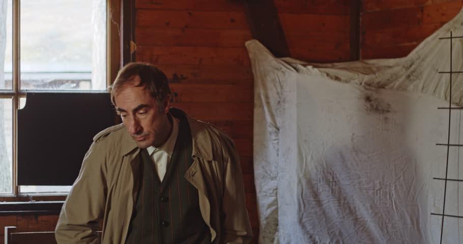 A secret agent dressed in a trench coat grabs a pill from his pocket and talks about it. The spy throws the capsule to someone else