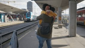 Loving African American couple embracing at the train station, preparing to go on their journey together, handheld shot. Travel and romance concepts. - Powered by Shutterstock - Get 15% off with code: PIKWIZARD15