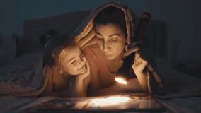 A mother and her little girl create memories while reading a bedtime story. Their shared laughter and bonding moments glow in the soft light. - Powered by Shutterstock - Get 15% off with code: PIKWIZARD15