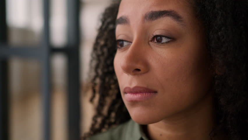 Sad sorrowful face upset worried alone girl African American ethnic woman lonely female lady desperate frustrated disappointed think health problem regret suffer looking away pensive feelings at home