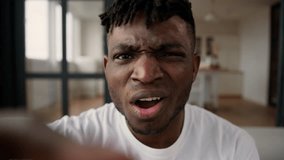 African man guy POV using mobile phone touchscreen scrolling screen social media male blogger influencer gadget addict browsing internet at home typing display confused upset shock read news disgust - Powered by Shutterstock - Get 15% off with code: PIKWIZARD15