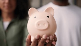 Couple hands African American family happy man woman male female hold piggy bank savings money planning future banking invest loan mortgage finance insurance household budget deposit credit payment - Powered by Shutterstock - Get 15% off with code: PIKWIZARD15