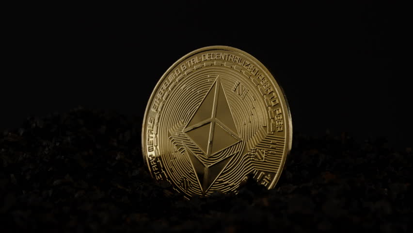 An Ethereum Coin Emerging from the Shadows, Soft Rays of Light Illuminating its Gold Surface and the Dark Stones Beneath, Representing Digital Wealth and Progress.