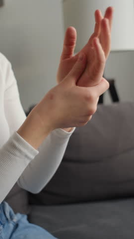 Vertical footage of rheumatism woman hand pain from cramp, trigger finger, wrist pain touching massaging, hand holding ache joint, arthritis inflammation. Chronic disease from injury