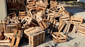 Stack of empty wooden crates leans against a building wall. Crates display signs of disarray and wear, showcasing a rustic, weathered charm - Powered by Shutterstock - Get 15% off with code: PIKWIZARD15