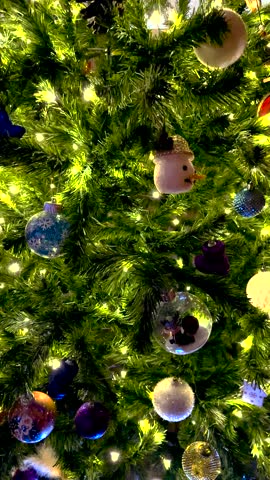 Christmas tree and decorations texture background. Decorated Xmas tree with gold garland, ornaments and balls
