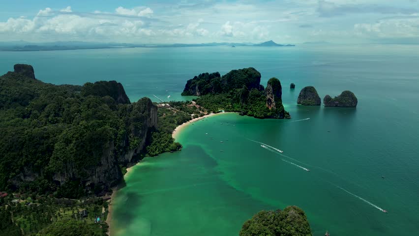 Aerial shot of the beautiful and rocky coasts, with marine traffic, at the province of Krabi, Thailand
