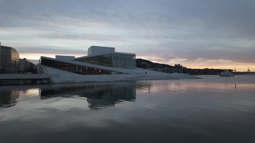 Oslo Opera House With Reflection On The Water During Sunset In Oslo, Norway. - wide shot