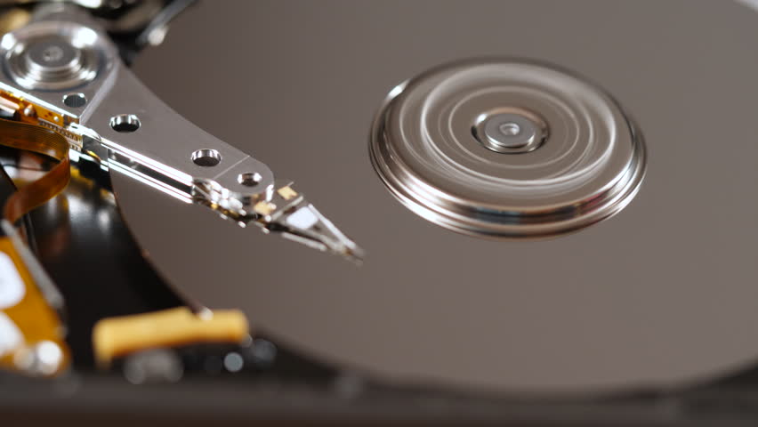 Cyberspace Protection of Personal Data on HDD. Macro Close Up Footage of Head of Hard Disk that Reads Information From Media. Computer Hard Drive Working Open With Moving Head.