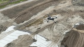 Aerial view of a drone flying over a construction site.  - Powered by Shutterstock - Get 15% off with code: PIKWIZARD15
