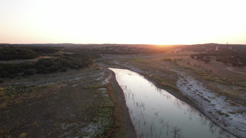 Drone view of Canyon Lake at sunset with low water levels, Texas Hill Country