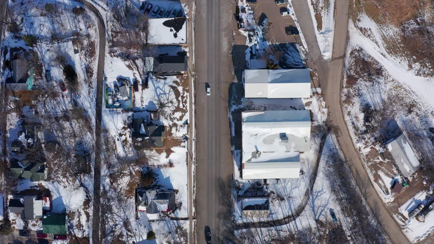 Top-Down Drone Footage of a Small Town in Winter With Snow-Covered Roads and Buildings - Iowa, 4K