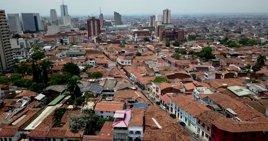 Drone footage capturing the vibrant cityscape of Cali, Colombia, highlighting houses, streets, and the dynamic urban environment from above