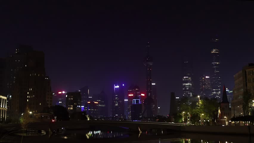 Shanghai Skyline at Night. Urban District, Huangpu River and skyscrappers. China. Illuminated cityscape. Waitan embankment