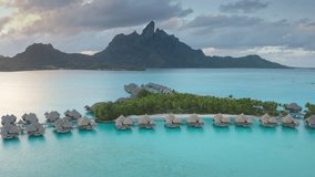 Drone fly over turquoise water lagoon and overwater bungalows resort, mount Otemanu in Bora Bora, French Polynesia. Popular travel destination, remote wild paradise, exotic summer travel. Aerial view - Powered by Shutterstock - Get 15% off with code: PIKWIZARD15