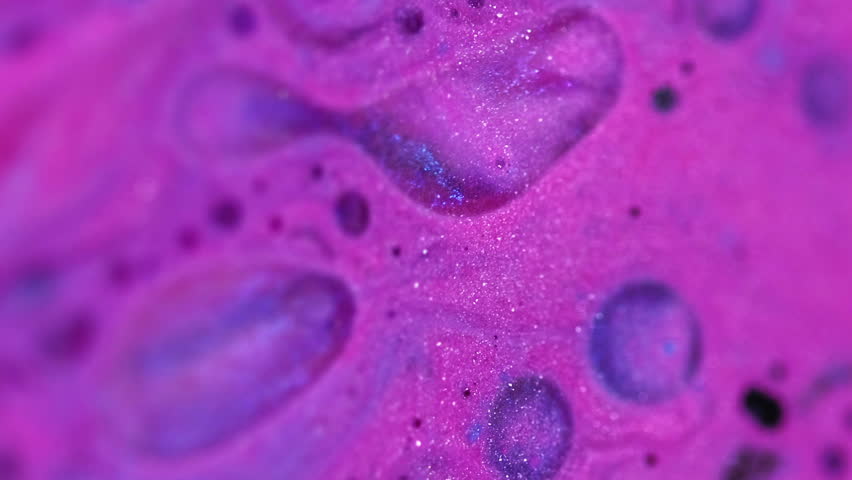 Acid liquid. Bubble ink. Defocused pink purple blue color shimmer oil drops spill shiny paint foam texture flow motion abstract art background.