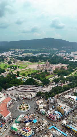 Vertical aerial view of Mysore downtown with the famous Mysore Palace in in the background, India. Scenic surroundings with distant hills, capturing the historic charm of this iconic city