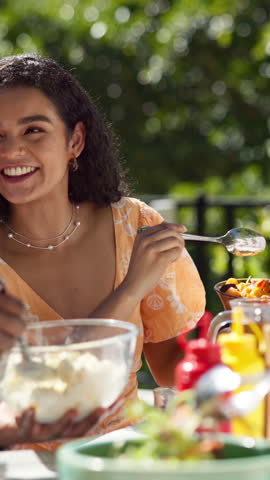 Food, bonding and barbecue with friends in garden for celebration, new years event or lunch. Share, party and eating with group of people on patio of home for summer social, reunion and bbq together