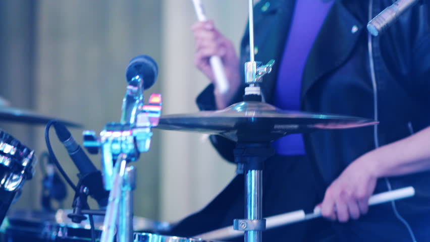 Close-up of musician playing the drums. Playing drums at a concert. A drummer plays a percussion instrument.