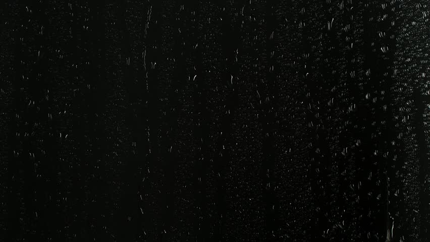 Closeup water rainfall, rain drops falling on window glass over black background