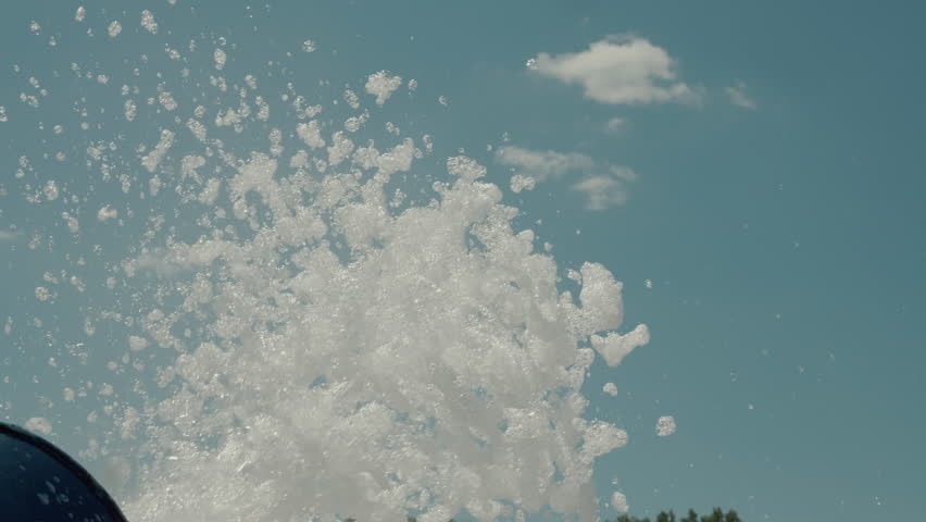 Foam jumping up at an amusement Aqua Park show. Colorful water park. Summer attraction.