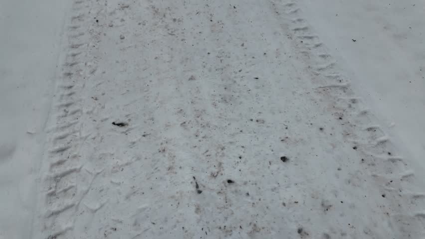 tire tracks on snow. tire tread marks on ground. winter tires. winter tire imprint on sega and ice. slow motion video