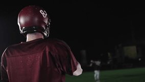 An American football player practicing throwing and catching the ball on a field - Powered by Shutterstock - Get 15% off with code: PIKWIZARD15