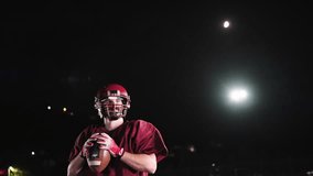 An American football player practicing throwing and catching the ball on a field - Powered by Shutterstock - Get 15% off with code: PIKWIZARD15