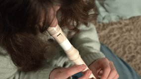 A teenage girl is playing a recorder flute. Close-up - Powered by Shutterstock - Get 15% off with code: PIKWIZARD15