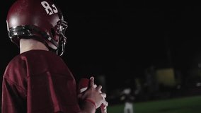 An American football player practicing throwing and catching the ball on a field - Powered by Shutterstock - Get 15% off with code: PIKWIZARD15