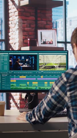 Remotely working videographer doing video montage using specialized software applications. Video editor using editing tools on PC to cut movie project footage in home office, camera A