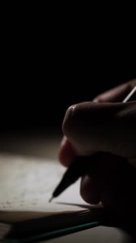 man journaling his thoughts into notebook, because he has some sort of depression, problems and want to find out and help himself without psychologist