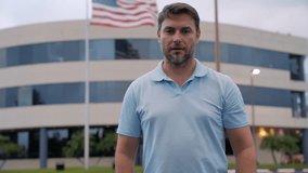A successful adult male shows a confident thumbs up near the American flag. Caucasian man with thumbs up because something good has happened. thumbs up smiling and happy for success. Winner gesture. - Powered by Shutterstock - Get 15% off with code: PIKWIZARD15