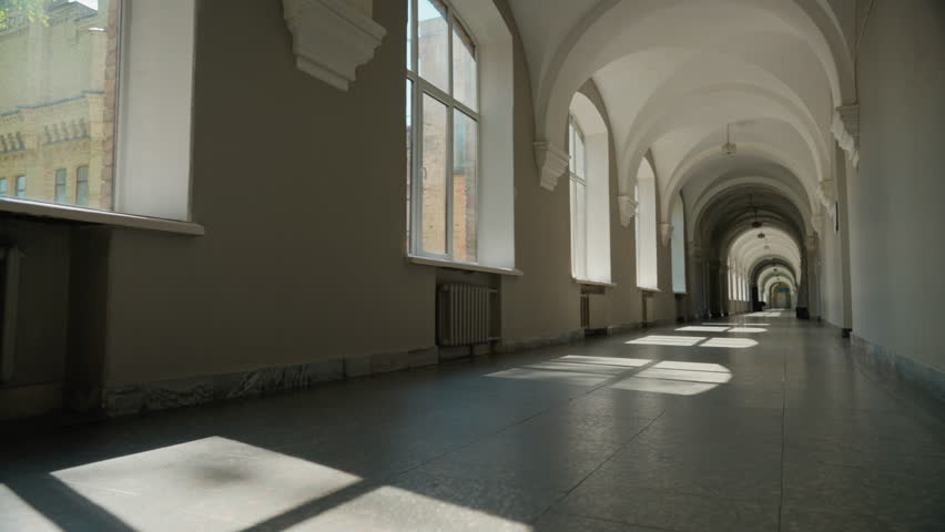 Empty corridor in university hall long college hallway academy high school indoors room without people students indoor building interior studying education learning sunlight sunbeams sun light windows