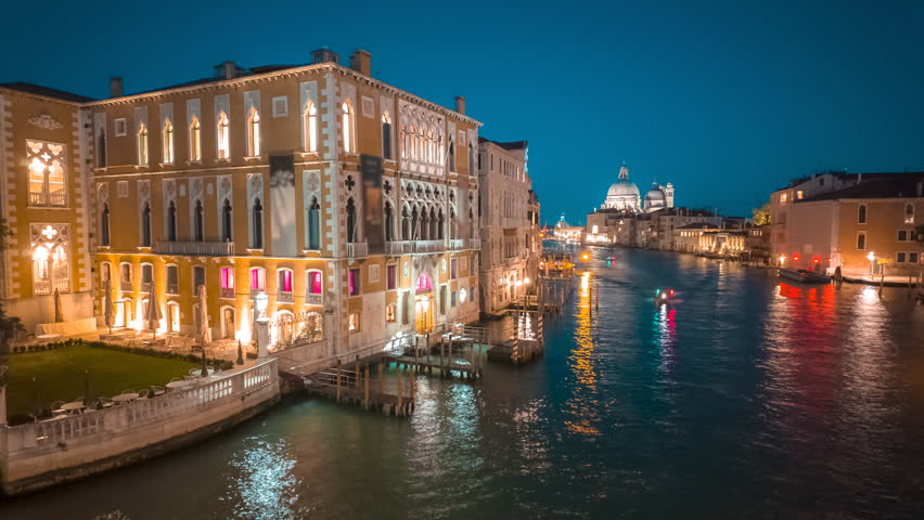 Amazing night timelapse of the Grand Canal in Venice, Italy featuring the famous Basilica Santa Maria della Salute. Venice is an archipelago of 126 islands linked by 472 bridges
