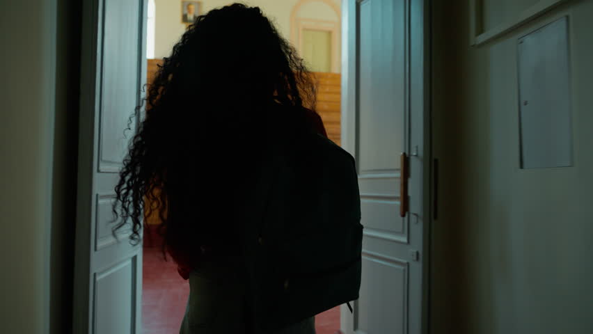 Back view from behind Hispanic student girl Latina woman Caucasian female lady go amazed wonder surprised come in walking in class auditorium university college academy indoors looking around studying