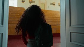 Back view from behind Hispanic student girl Latina woman Caucasian female lady go amazed wonder surprised come in walking in class auditorium university college academy indoors looking around studying - Powered by Shutterstock - Get 15% off with code: PIKWIZARD15