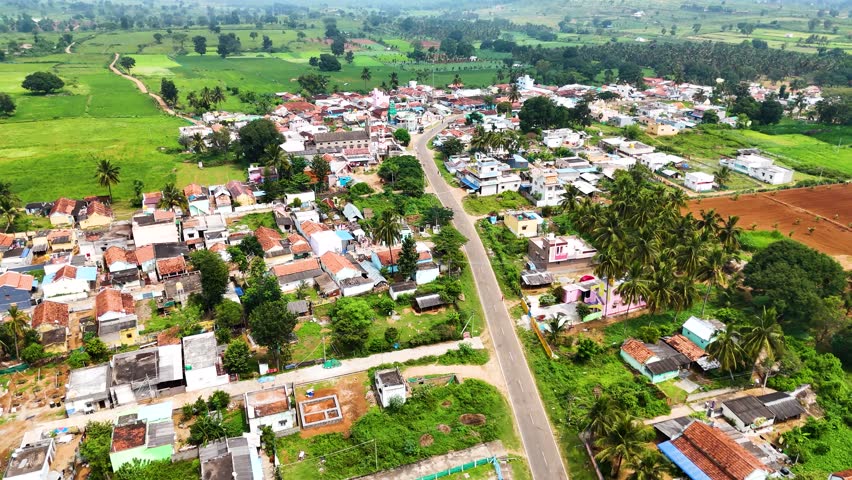 Drone fly over of Gumatapura village in Karnataka, surrounded by lush farmland and rural landscapes, the site of the unique Cow Dung Festival during Diwali. South India