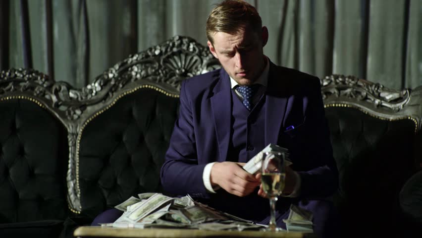 American money business. Rich gentleman count money. Gangster in dark room counting money dollars. Rich business man. Rich man in suit count dollars banknotes. Rich man with lots of money in dollars.