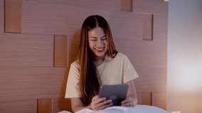 Beautiful Asian woman holding laptop in hand, women watch movies, woman face is happy, with small smile and big smile with series is watching, put hand on chin in embarrassed manner. - Powered by Shutterstock - Get 15% off with code: PIKWIZARD15