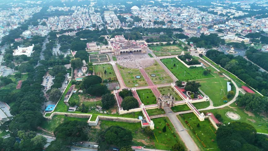 Drone view of Mysore Palace in Mysuru, India. Showcasing lush gardens, grand architecture, capturing the historic charm of this iconic landmark.