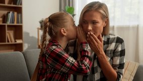 Mischievous Caucasian girl child whispering secret in ear female mother mom shocked surprised woman listen little daughter gossip telling interesting story rumor kid speak with parent at home family - Powered by Shutterstock - Get 15% off with code: PIKWIZARD15