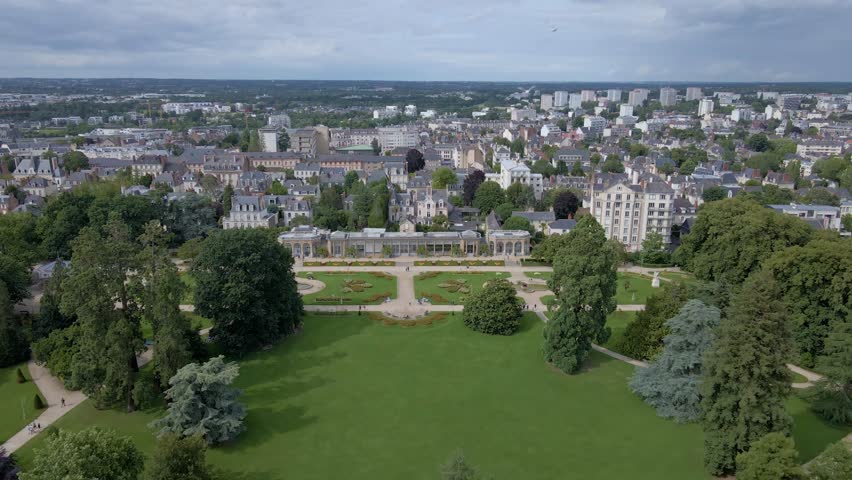 Beautiful panoramic drone movement towards the Parc du Thabor botanical garden, Rennes, France.
