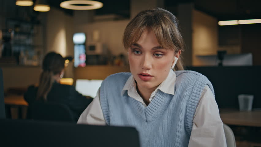 Confident employee video calling laptop camera having virtual conference sitting office closeup. Serious business woman talking discussing work results. Girl manager sharing news at online meeting 