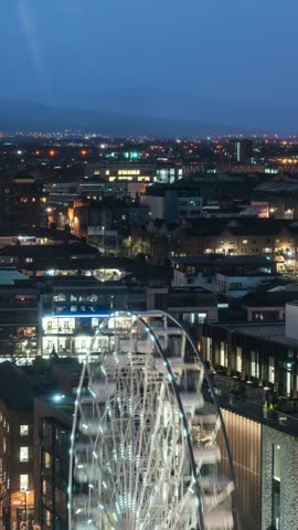 The Ferris wheel spins against the city skyline. Dublin Christmas market. Verticals, Reels, Shorts. 