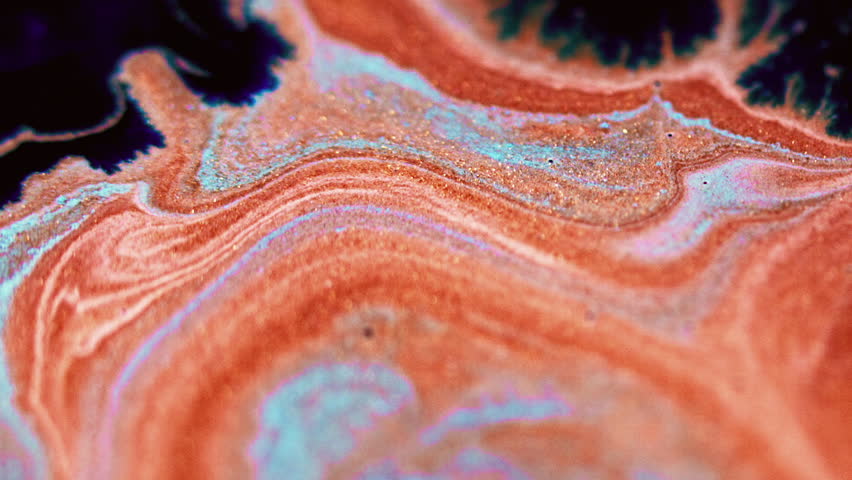 Glitter splatter. Sparkling ink flow. Defocused black blue orange color shimmering marble texture paint emulsion drop spreading abstract art background.