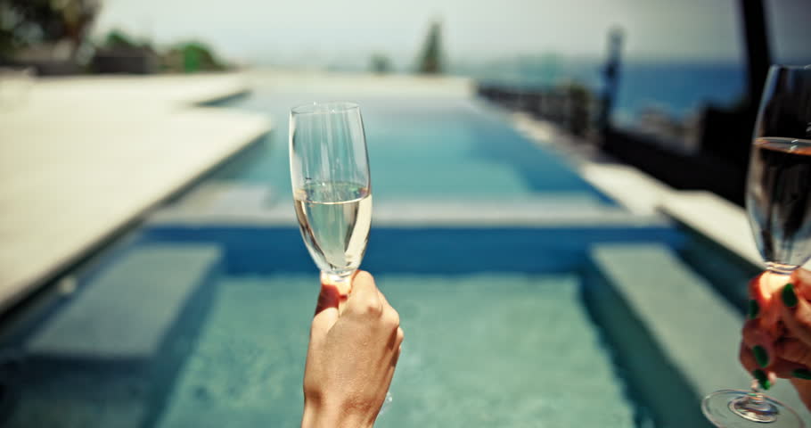 Bachelorette party, champagne and cheers with women at pool for travel, celebration and support. Happiness, destination wedding and toast with back of friends in outdoor for summer, event and team